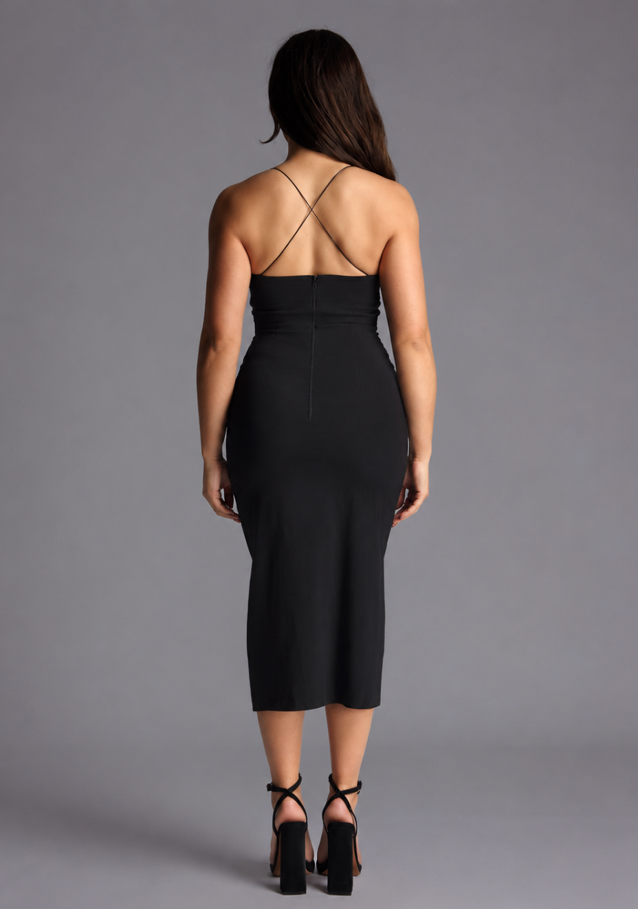 Back image of a model wearing the VSPR Beryl Petite Strappy Bodycon Black Midaxi Dress in Black, featuring a sculpted silhouette and delicate crossover straps designed for a polished occasion look.