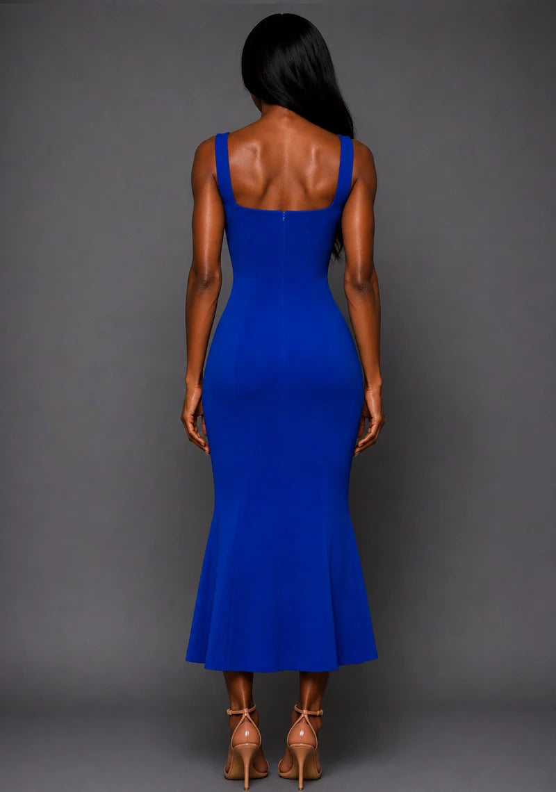 Back image of a model wearing the VSPR Marianna Square Neckline Fishtail Cobalt Midaxi Dress in Cobalt Blue from the back, highlighting the sleek silhouette, structured design, and midaxi length against a grey studio backdrop.