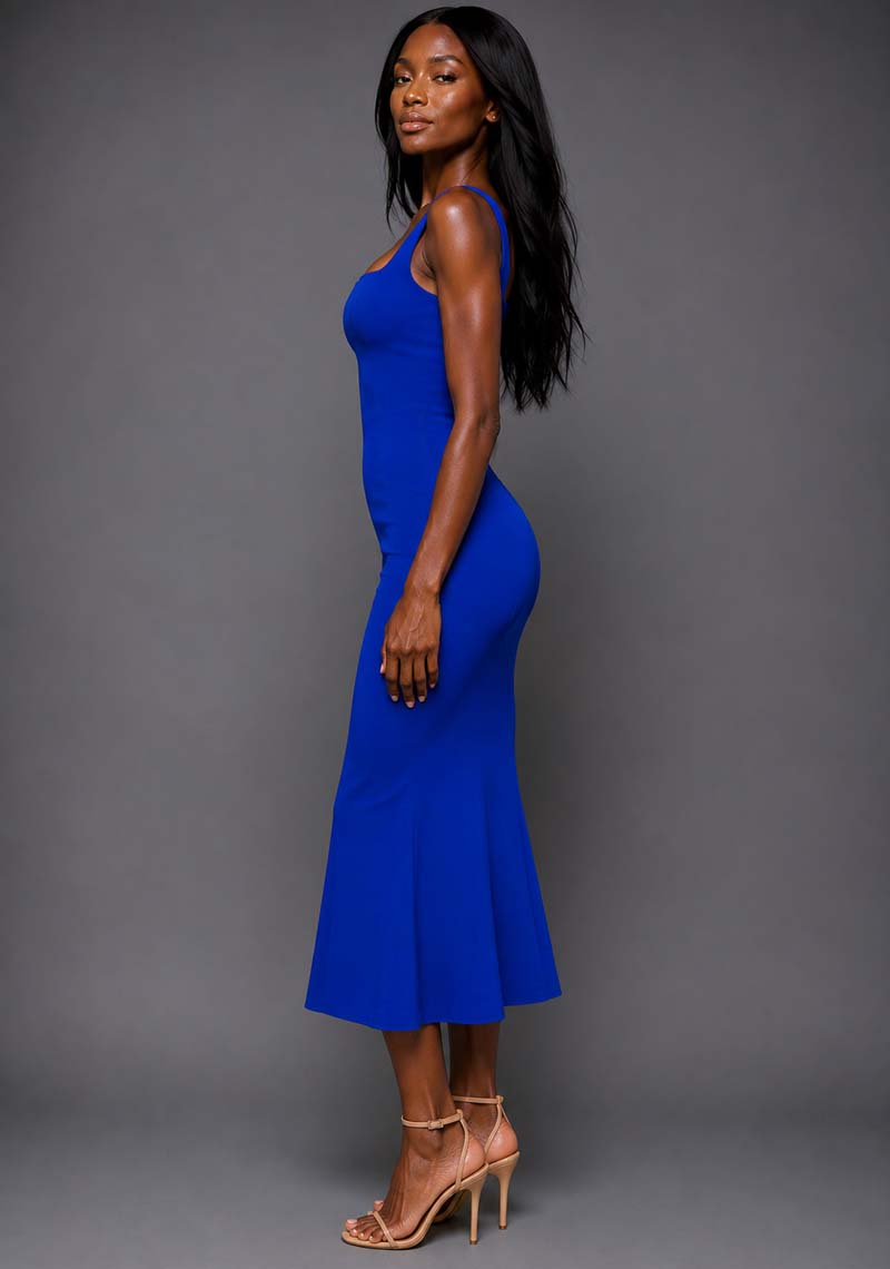 Side back image of a model wearing the VSPR Marianna Square Neckline Fishtail Cobalt Midaxi Dress in Cobalt Blue from a side front angle, featuring wide straps, a fitted silhouette, and graceful mermaid hem.