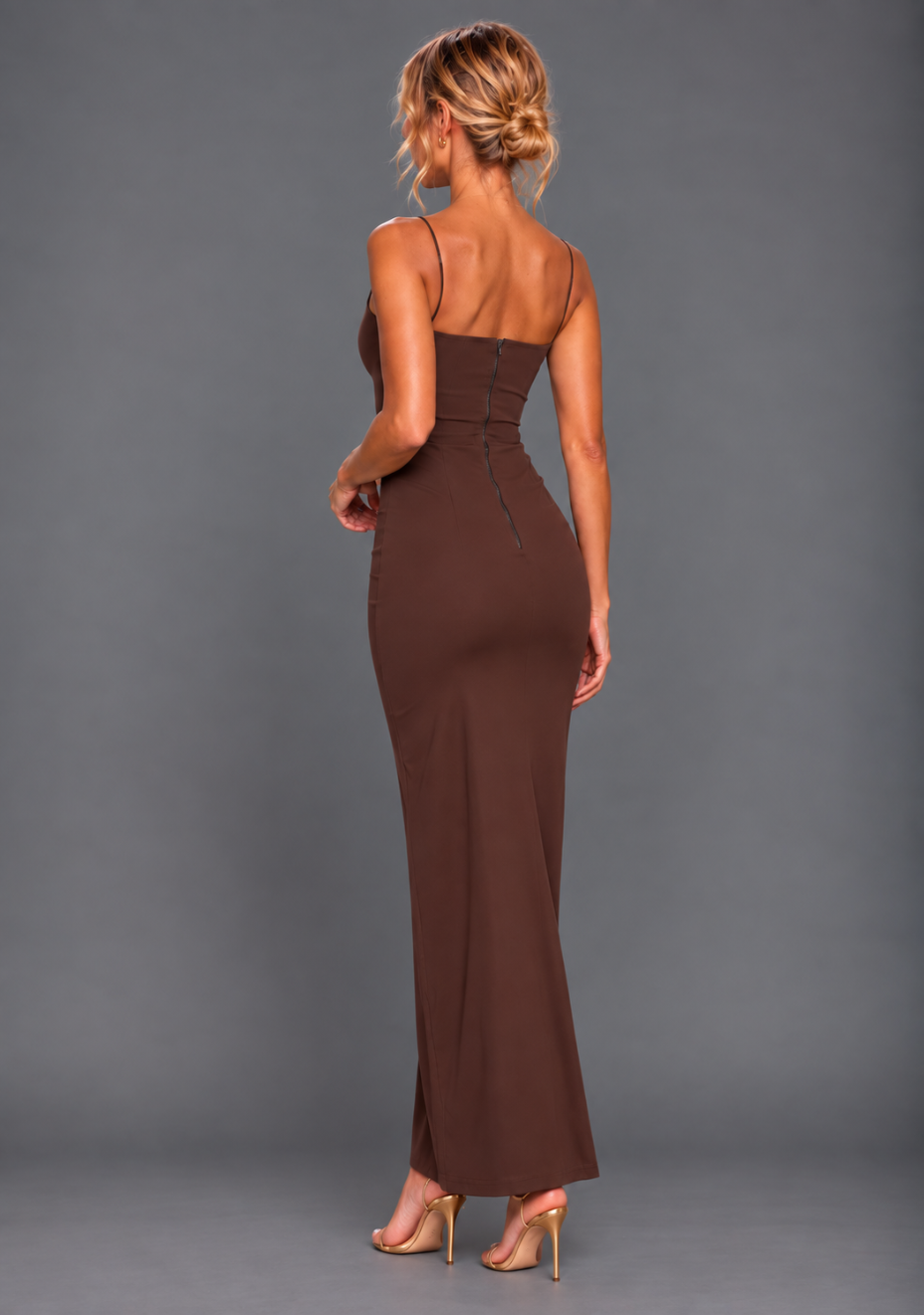 Side back image of a model wearing the VSPR Suki Cami Strap Chocolate Maxi Dress, highlighting the smooth fitted silhouette and concealed back zip against a grey studio backdrop.