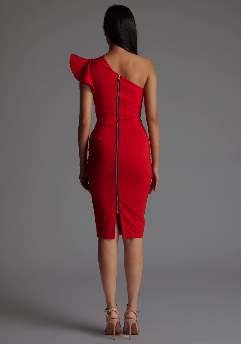 Back image of a model wearing a red one shoulder midi dress with a stunning one-shoulder design with ruffle detail and an asymmetric neckline, all tied together with a gold centre back zip. The design featured is the Vesper Zanab Red One Shoulder Midi Dress.