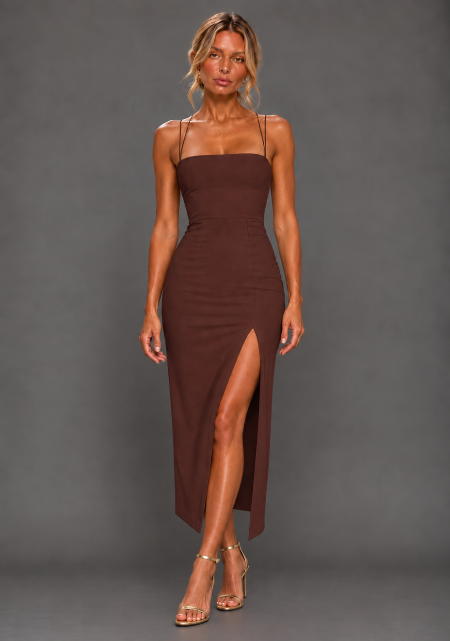 Front image of a model wearing the VSPR Alyssa Strappy Thigh Split Chocolate Midaxi Dress with a straight-across neckline, slender straps and subtle front skirt split against a grey studio backdrop.
