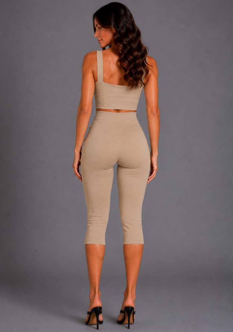 Back image of a model wearing the VSPR Athena Square Neckline Button Detail Taupe Crop Top in taupe, featuring a sleek fitted silhouette, structured construction, and contemporary cropped length, against a grey studio backdrop.