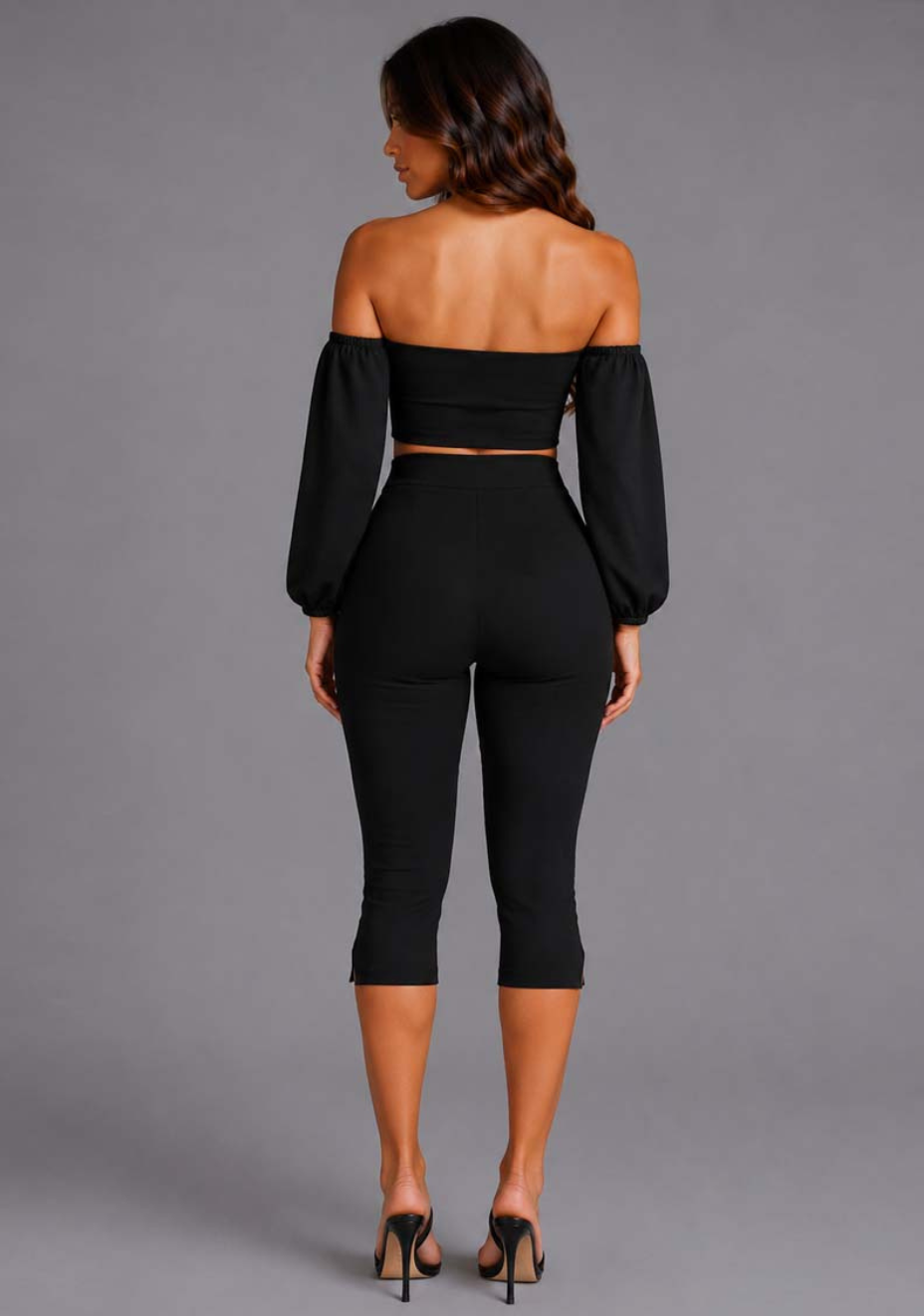 Back image of a model wearing the VSPR Belle Sweetheart Neckline Puff Sleeve Black Top, showcasing the clean fitted silhouette and dramatic puff sleeves against a grey studio backdrop.