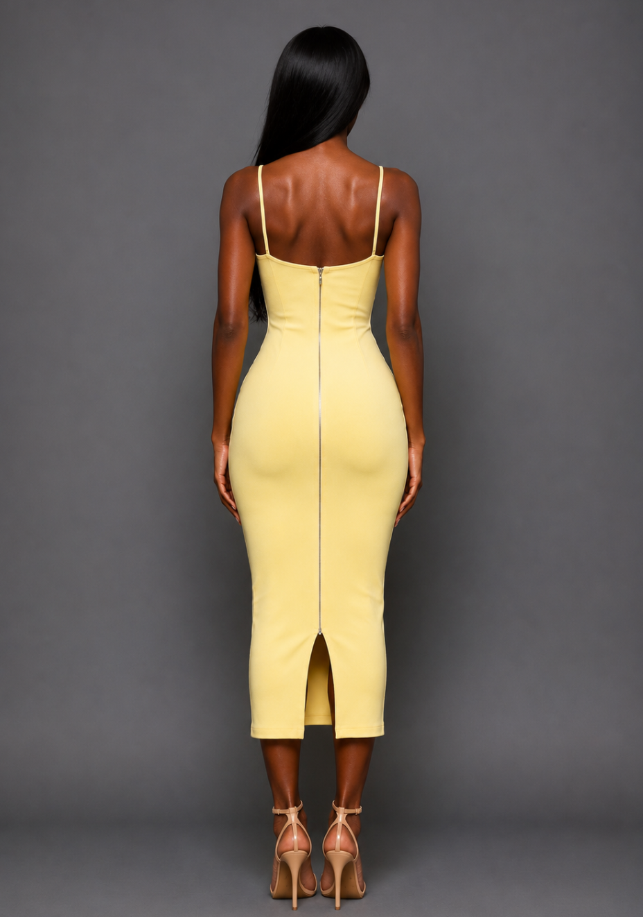 Back image of a model wearing the VSPR Nixi Square Neckline Midaxi Dress in Lemon, featuring the statement gold centre-back zip, fitted silhouette, and midaxi length against a grey studio backdrop.