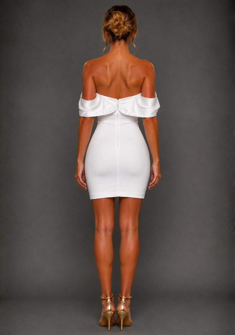 Back image of a model wearing the Vesper Paloma Bardot Satin Sleeve Ivory Mini Dress highlighting the Bardot neckline, satin sleeves and fitted silhouette.