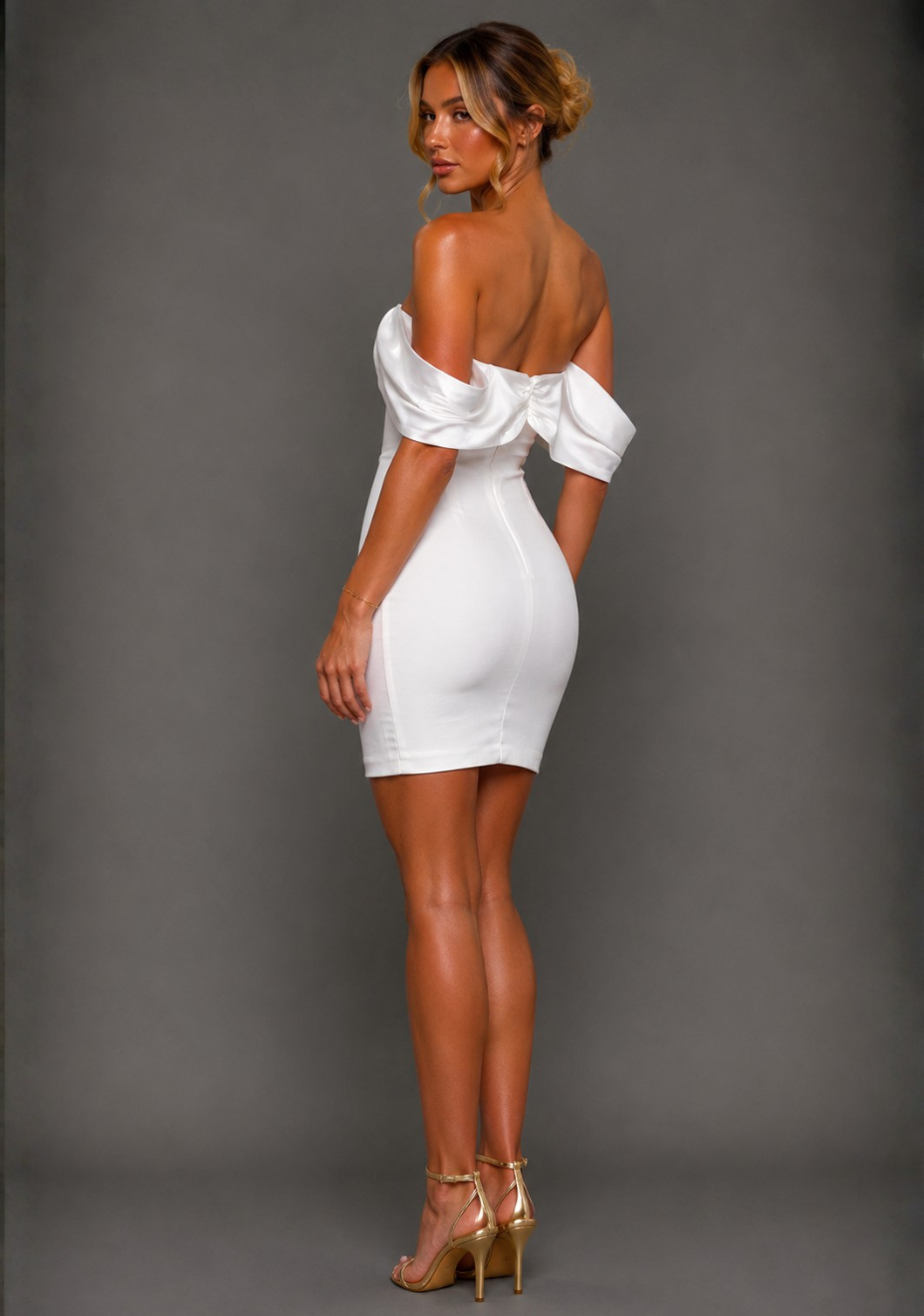 Side back image of a model wearing the Vesper Paloma Bardot Satin Sleeve Ivory Mini Dress displaying the Bardot neckline and satin sleeves.