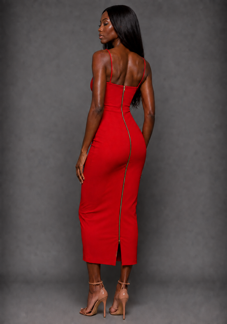 Side back image of a model wearing the VSPR Roxanne Front Cut Out Cami Strap Midaxi Dress in Red, highlighting the sleek body-skimming silhouette and flowing midaxi length against a grey studio backdrop.