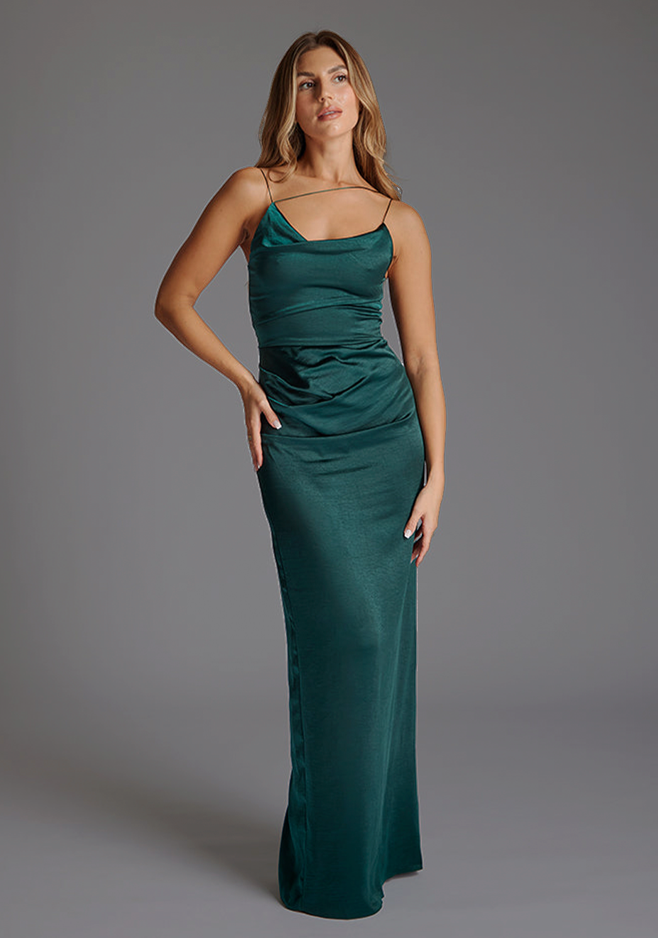 Front image of a model wearing a pine green maxi dres with a chic thin straps and featuring a tasteful ruched design and  complete with a convenient back zip. The design featured is the Vesper Lorah Satin Drape Maxi Dress in Pine Green.