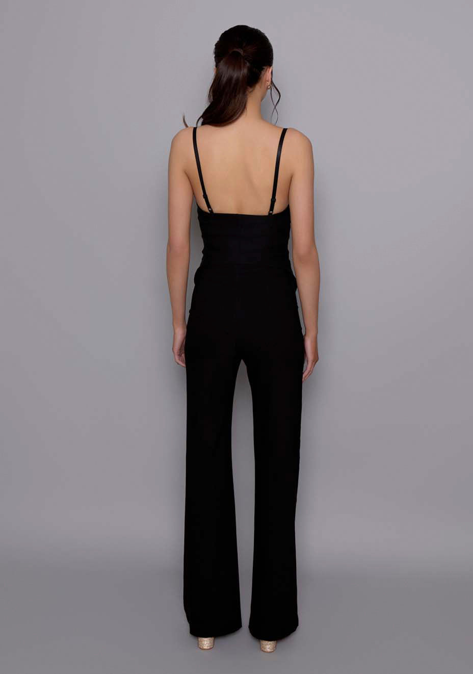 Back view of the VSPR Tyra tailored trousers in black, revealing the clean waistband, subtle seam detailing, and smooth fit over the hips.