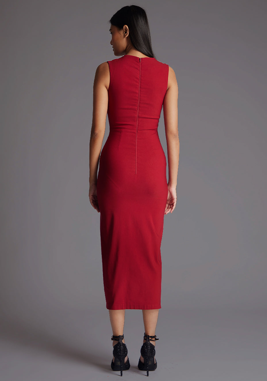 Back image of model wearing a wine midaxi dress with a asymmetric neckline, front cutout detail, front skirt split and center back zip. The design featured is the Vesper Queenie Wine Midaxi Dress.