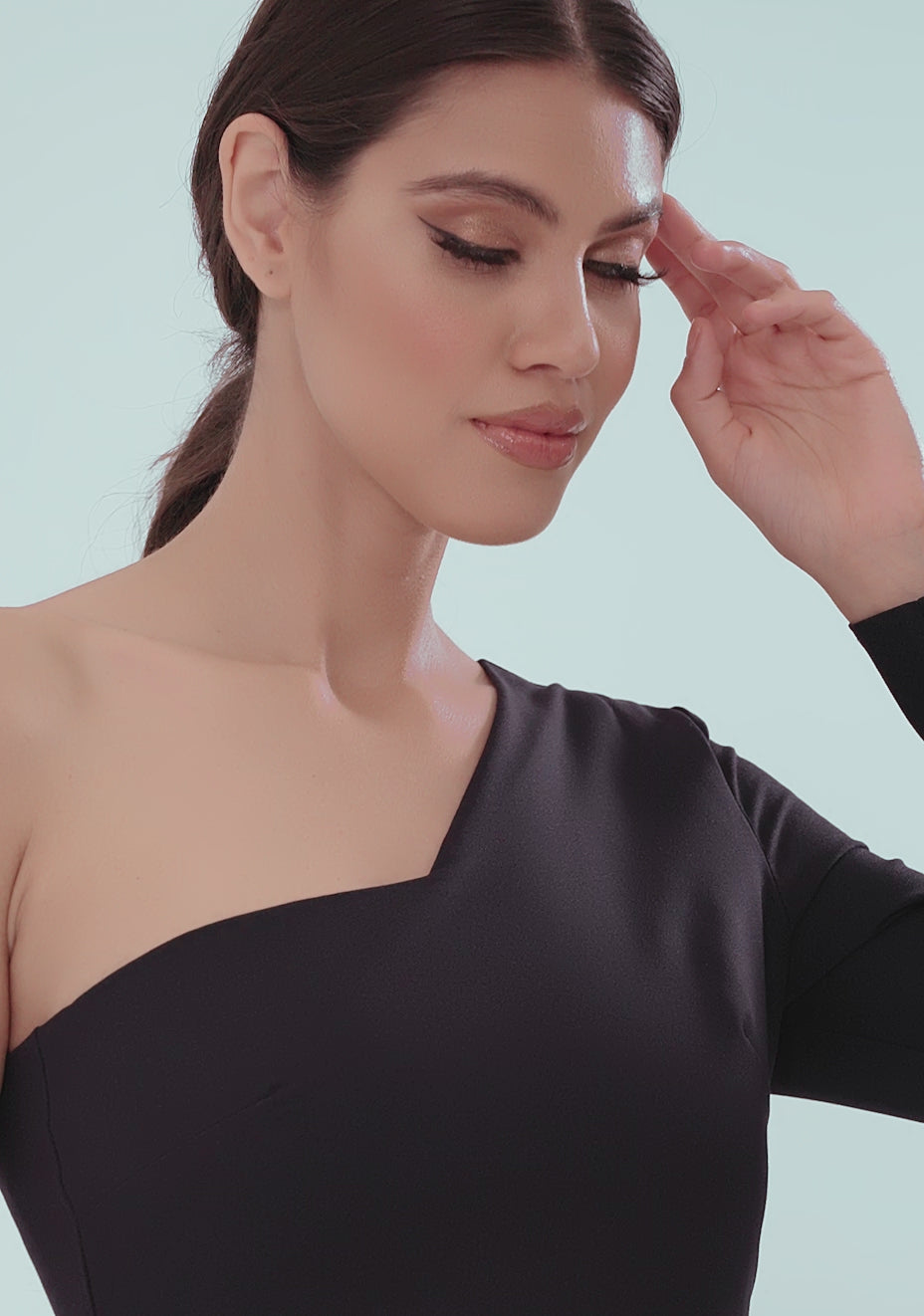 Model posing in the VSPR Sophia One Sleeve Maxi Dress in Navy, showcasing the bold asymmetric neckline, dramatic one-sleeve detail, and daring front skirt split. The luxurious fabric flows elegantly with each step, highlighting the dress’s flattering silhouette and modern design, perfect for evening events and formal occasions.